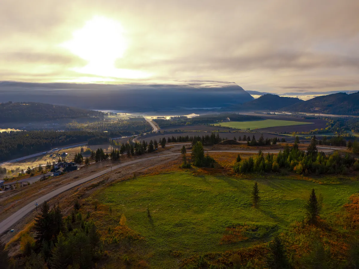Sunrise over the park meadow and valley on the west side of The Highlands at Blind Bay